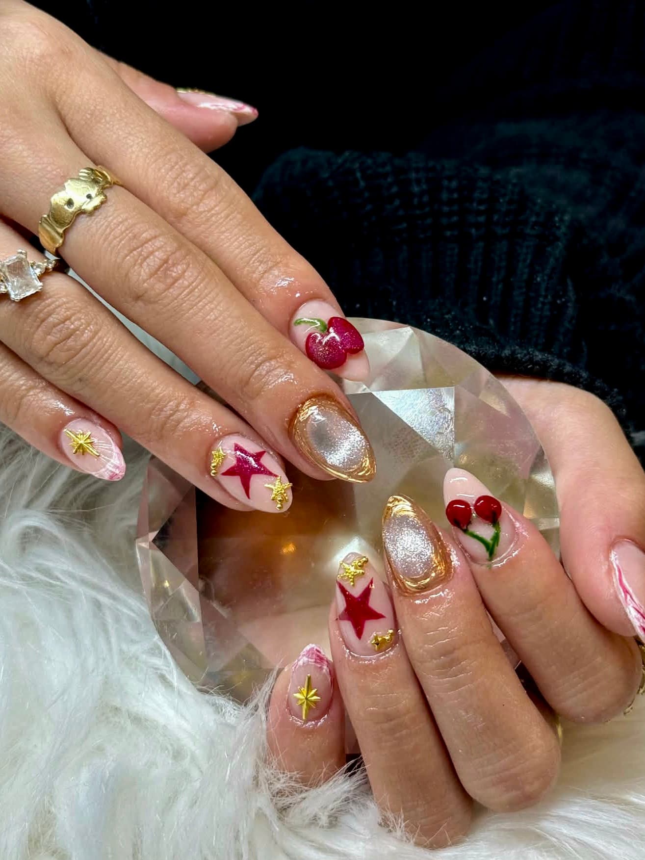 Cherry and gold star manicure by Blackrock Nails & Spa